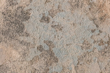 Peeling old plaster with damaged concrete wall cement weathered texture broken background