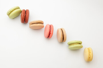 Three different colors macarons on a white background