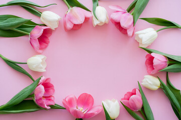 top view of frame with blooming flowers on pink.