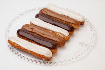 Different eclair cakes on a transparent glass dish