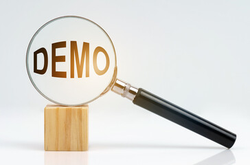 On a white surface there is a cube and a magnifying glass inside which is the inscription - demo