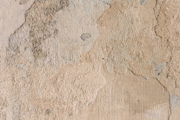 Peeling old plaster with damaged concrete wall cement weathered texture broken background