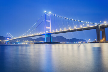 Suspension bridge to Park island at evening time. Hong Kong.