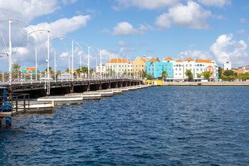 The famous Queen-Emma-Bridge with colorful buildings of the district Otrobanda in Willemstad, Curacao