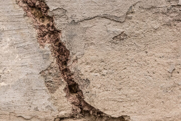 A crack in the old concrete is a close-up. Broken cement worn texture damage background