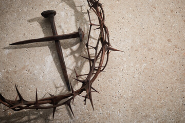 Easter concept. Crown of thorns with Nails on a stone background.