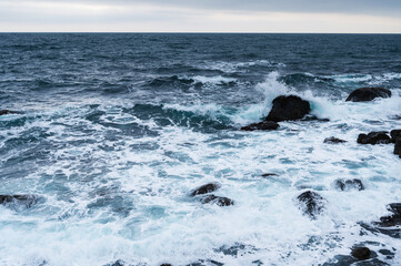 Storm on the blue sea, waves with foam