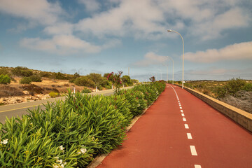 Picturesque bike path along the highway. Ayia Napa, Cyprus. - obrazy, fototapety, plakaty