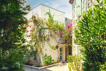 Fototapeta na wymiar Narrow street in old town of Marmaris, Turkey . Beautiful scenic old ancient white houses with flowers. Popular tourist vacation destination