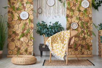 Boho living room design and wicker chair with plaid