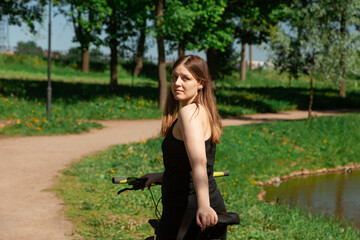 A girl in a sports uniform at the wheel of a bicycle