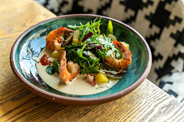 Fresh Shrimps, Avocado, Mango salad with lettuce green mix, herbs, lemon, healthy food.