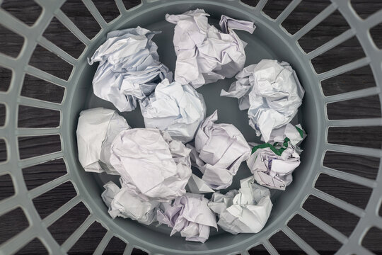 Recycle bin with crumpled papers. Crumpled sheets of paper in the trash.