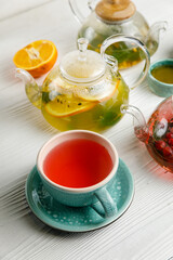 Hot tea in teapots on a wooden table
