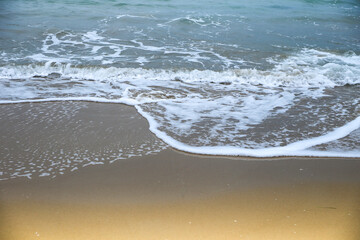Waves drawing geometric shapes on the shore