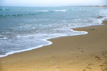 Waves drawing geometric shapes on the shore