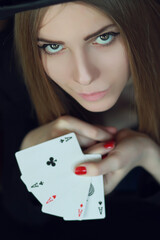 young woman playing in the gambling on black background