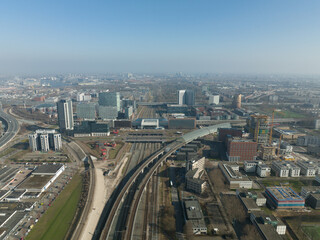 Railway station transportation infrastructure metro train station in Amsterdam Sloterdijk, The Netherlands. Aerial of highway urban transit platform and office buildings skyline.