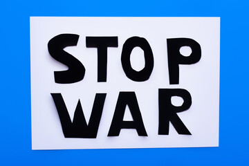 Top view of stop war lettering on white and blue background.