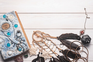 White book of magic on the white wooden desk background with copy space.