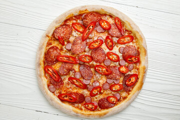 Italian pizza on a white wooden table
