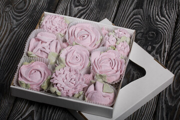 Roses, tulips and chrysanthemums from marshmallows. Zephyr flowers. In craft packaging.