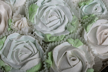 Homemade marshmallows of different shapes and colors. Zephyr flowers.