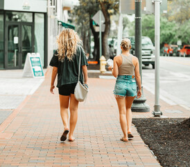 two women walking in the city summer lifestyle coconut grove miami 