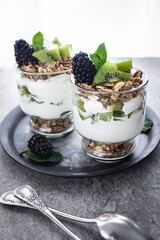 Parfait with kiwi, blackberries, granola and yogurt. Healthy and delicious dessert