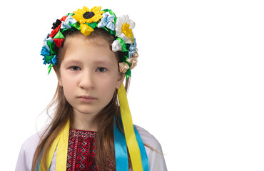 Portrait of a little Ukrainian girl with tearful eyes. Child in national dress.