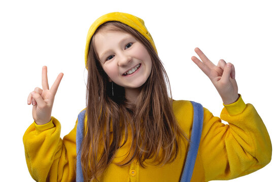 Little cute cheerful girl 10 years old posing in yellow pajamas. Studio photo.