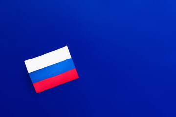 Top view of russian flag on blue background.