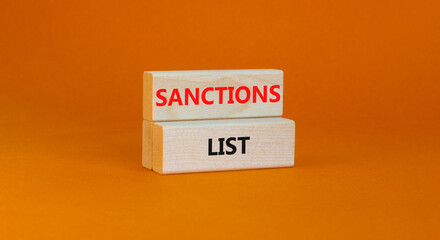 Sanctions list symbol. Wooden blocks with concept words Sanctions list on beautiful orange background. Business political sanctions list concept. Copy space.
