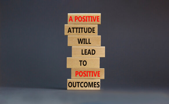 Think positive symbol. Wood blocks with words A positive attitude will come to positive outcomes. Beautiful grey background copy space. Business motivational think positive concept.