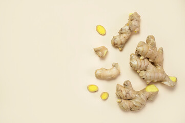 Fresh ginger root chopped ginger pieces on beige background top view flat lay. Spice for cooking,...