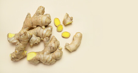 Fresh ginger root chopped ginger pieces on beige background top view flat lay. Spice for cooking, herbal tea with ginger to boost immunity. Natural organic ginger for health medicine protection colds