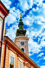 Fototapeta na wymiar Bell and clock tower of Serbian Orthodox church in Novi Sad, Serbia.
