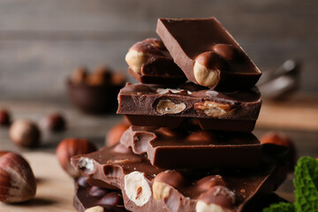 Pieces of tasty chocolate with hazelnuts, closeup