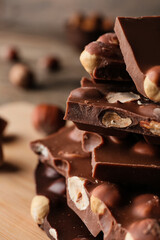 Pieces of tasty chocolate with hazelnuts, closeup