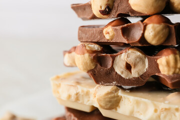 Pieces of tasty chocolate with hazelnuts, closeup
