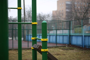 City playground for sports. Metal structures for pull-ups. Horizontal bars, bars, ladders made of green material
