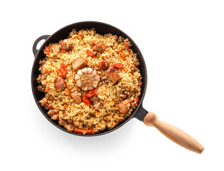 Frying pan with tasty Asian pilaf on white background