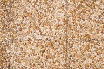 Road tiles with brown pebbles. Small marine stones. Abstract texture background