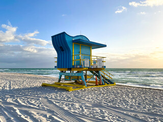 Iconic blue and yellow lifeguard house in Miami Beach. Beautiful sky at sunrise