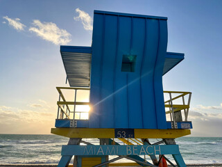 Iconic blue and yellow lifeguard house in Miami Beach. Beautiful sky at sunrise