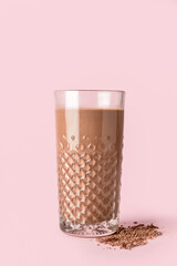Glass of delicious chocolate milk on color background