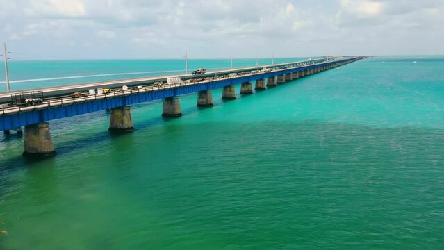 Old bridge running over ocean surface, next to operating one in Florida Keys, USA. Aerial drone view of Old Bahia bridge along ocean with horizontal oceanscape, copy space. Concept of architecture