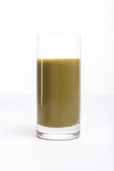 green smoothie in a glass on a white background