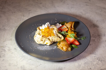 pancake with cottage cheese and fruit on a gray plate