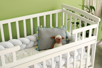 Cozy baby crib near color wall in stylish children's room - obrazy, fototapety, plakaty